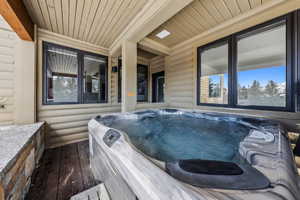 Wooden deck featuring a hot tub