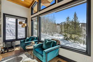 Sunroom featuring wood ceiling and vaulted ceiling