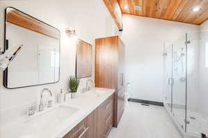 Bathroom featuring beam ceiling, an enclosed shower, toilet, vanity, and wood ceiling