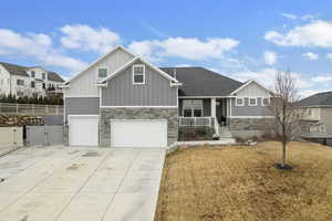 Craftsman inspired home with a front yard, a porch, and a garage