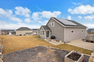 Rear view of property featuring a yard