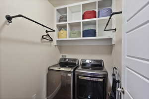 Clothes washing area featuring washing machine and dryer