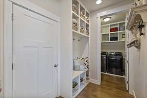 Mudroom featuring washer and dryer and dark wood-type flooring