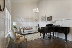 Living area featuring a chandelier, dark hardwood / wood-style floors, and lofted ceiling