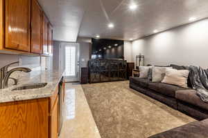 Living room featuring a textured ceiling and sink