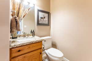 Bathroom featuring tile patterned flooring, vanity, and toilet