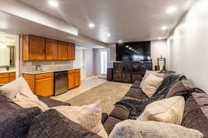 Tiled living room with a textured ceiling and sink