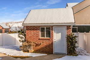 Snow covered property entrance with a mountain view