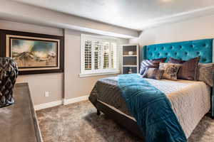 Bedroom with carpet flooring and a textured ceiling