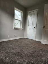 Spare room with carpet flooring and a textured ceiling