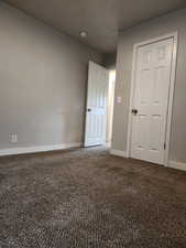 Unfurnished bedroom featuring carpet