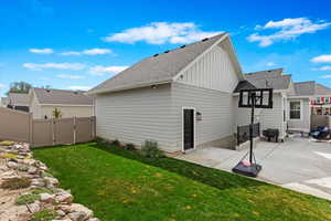 Back of property featuring a yard and a patio