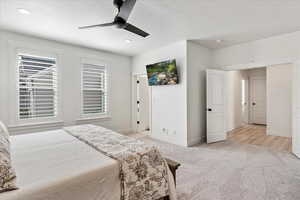 Carpeted bedroom featuring ceiling fan