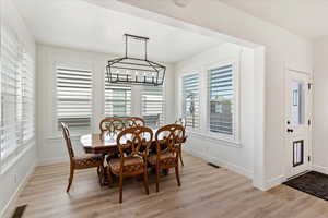 Dining area featuring a chandelier and light hardwood / wood-style floors