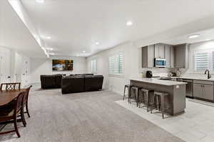 Living room featuring sink and light colored carpet