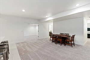 Dining space with light colored carpet