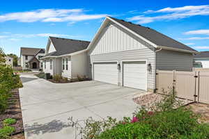 View of property exterior with central AC and a garage