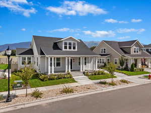 View of front of home featuring a mountain view and a porch