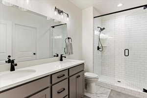 Bathroom featuring vanity and a shower with shower door