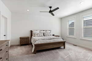 Carpeted bedroom with ceiling fan