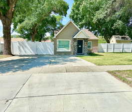 View of front of house with gated yard and RV parking