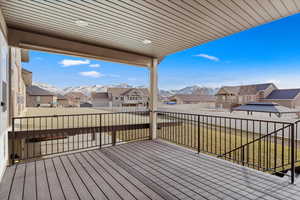 Deck featuring a mountain view and a yard