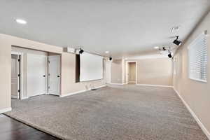 Cinema room featuring a textured ceiling