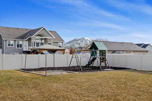 View of yard with a gazebo, a mountain view, and a playground