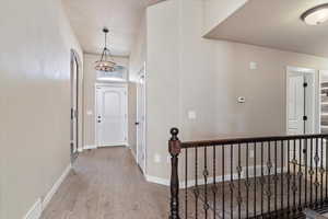 Hallway featuring light wood-type flooring