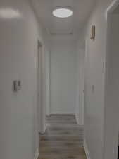 Hall featuring a textured ceiling and dark hardwood / wood-style floors