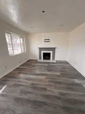 Unfurnished living room with dark hardwood / wood-style flooring