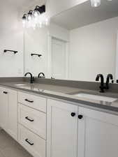 Upstairs Bathroom with 2 sinks in vanity and shower/tub and toilet in separate room for functionality.