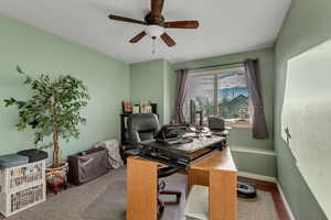 Office with hardwood / wood-style flooring and ceiling fan