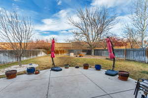 View of yard with a water view and a patio