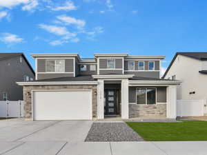 View of front of home with a front yard and a garage