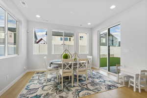 Dining space with light hardwood / wood-style flooring