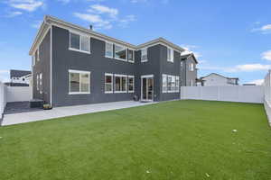 Back of house featuring a patio area, a yard, and central AC