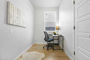 Office with light hardwood / wood-style floors