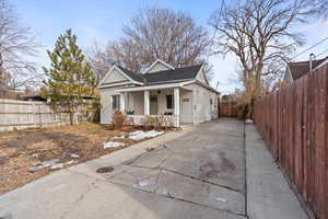 View of side of home featuring covered porch