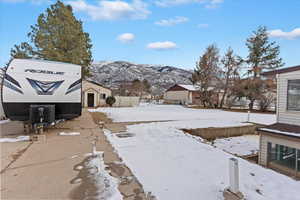 Yard covered in snow with a mountain view