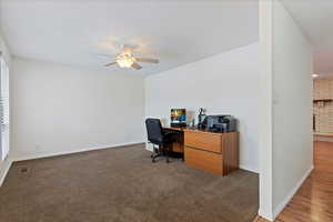 Office space featuring ceiling fan, a textured ceiling, and dark colored carpet