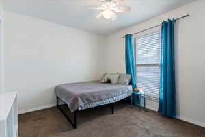 Carpeted bedroom with ceiling fan