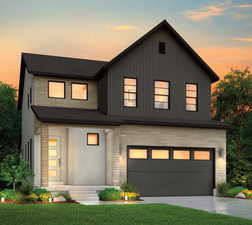 View of front facade with a lawn and a garage