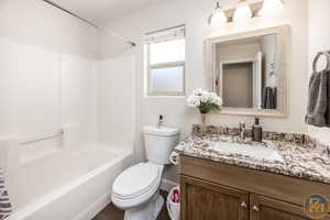 Full bathroom featuring vanity, toilet, and shower / bath combination