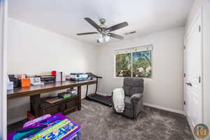 Interior space featuring carpet flooring and ceiling fan