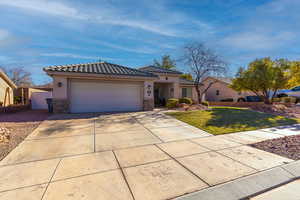 Mediterranean / spanish house featuring a garage and a front lawn