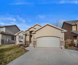 View of front of home featuring a front lawn and a garage