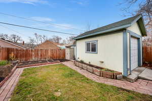 View of yard with a garage and an outdoor structure