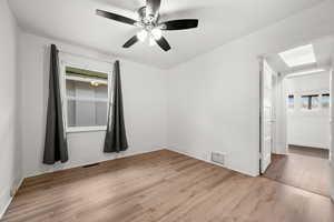 Empty room featuring ceiling fan and light hardwood / wood-style flooring