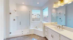 Bathroom featuring vanity, tile patterned floors, and shower with separate bathtub